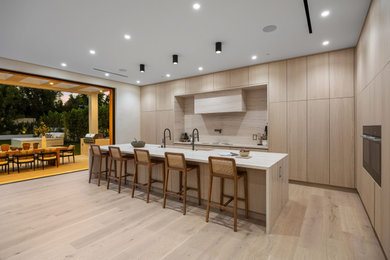 Inspiration for a huge modern l-shaped light wood floor and beige floor kitchen remodel in Dallas with a single-bowl sink, flat-panel cabinets, light wood cabinets, quartzite countertops, multicolored backsplash, stainless steel appliances and multicolored countertops