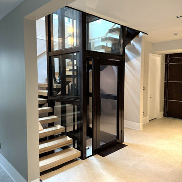 Project #136 | Modern Floating Staircase Encircling Glass Elevator