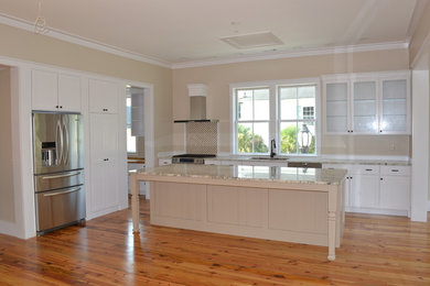 Example of a classic open concept kitchen design in Charleston with white cabinets, wood countertops and stainless steel appliances