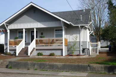 Patio - mid-sized craftsman front yard stone patio idea in Seattle with a roof extension