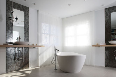 Inspiration for a modern bathroom in DC Metro with a freestanding tub and a vessel sink.