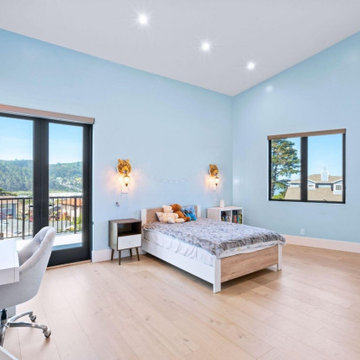 Light-Filled Bedroom with Balcony Access and Soft Blue Walls