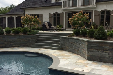 Example of a large classic backyard stone patio container garden design in New York