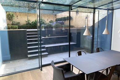 Medium sized contemporary bungalow glass and rear house exterior in London.