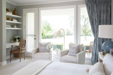 Large trendy guest carpeted and multicolored floor bedroom photo in Other with beige walls