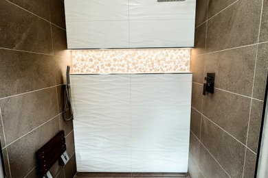 Inspiration for a mid-sized timeless master white tile and porcelain tile porcelain tile and beige floor walk-in shower remodel in Portland with a bidet, a hinged shower door and a niche