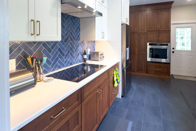 Inspiration for a large timeless galley porcelain tile and gray floor enclosed kitchen remodel in Boston with shaker cabinets, medium tone wood cabinets, quartz countertops, blue backsplash, subway tile backsplash, stainless steel appliances and white countertops