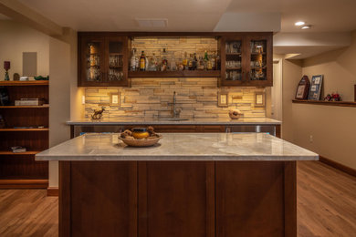 Transitional single-wall brown floor wet bar photo in Denver with an undermount sink, shaker cabinets, brown cabinets, quartz countertops, beige backsplash, stone tile backsplash and beige countertops