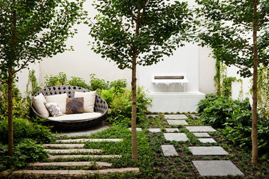 Design ideas for a mid-sized transitional partial sun courtyard concrete paver landscaping in New York.