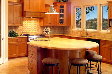 Mid-sized arts and crafts l-shaped ceramic tile and beige floor enclosed kitchen photo in Sacramento with a double-bowl sink, shaker cabinets, medium tone wood cabinets, granite countertops, beige backsplash, ceramic backsplash, stainless steel appliances and an island