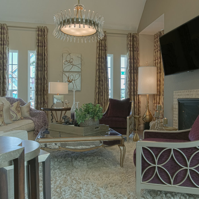 Using gold and purple to accent the neutral backgrounds, we created a glamorous space reminiscent of Hollywood.  An elegant light fixture and interesting lamps accent the gorgeous purple velvet chairs