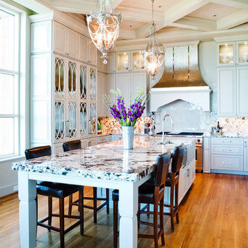 Elegant Mirrored Kitchen Cabinetry with Metal Hood St. Louis, MO