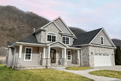Example of a transitional gray two-story mixed siding exterior home design in Huntington with a shingle roof