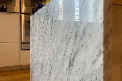 Design ideas for a contemporary kitchen with marble benchtops.