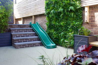 Inspiration for a small modern courtyard shaded formal garden for summer in Other with decking.