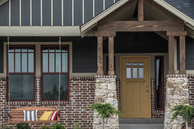 Large arts and crafts gray one-story mixed siding exterior home photo in Oklahoma City with a shingle roof