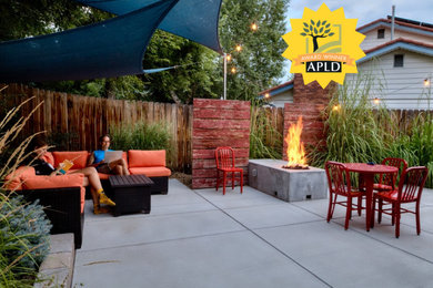 Patio - small modern backyard concrete paver patio idea in Denver with a fire pit