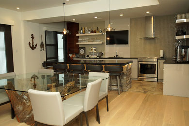 Large minimalist l-shaped seated home bar photo in Other with an undermount sink, flat-panel cabinets, gray cabinets, quartz countertops, gray backsplash, stone slab backsplash and black countertops