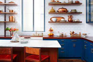 Mid-sized eclectic l-shaped dark wood floor open concept kitchen photo in San Francisco with a farmhouse sink, shaker cabinets, blue cabinets, wood countertops, white backsplash, subway tile backsplash and an island
