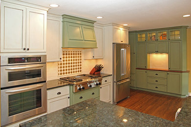 Large eclectic u-shaped dark wood floor eat-in kitchen photo in Minneapolis with a farmhouse sink, shaker cabinets, green cabinets, granite countertops, white backsplash, ceramic backsplash, stainless steel appliances and a peninsula