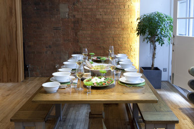 Inspiration for a contemporary dining room in London with light hardwood floors.