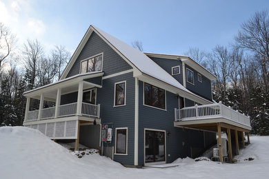 Mid-sized mountain style blue three-story concrete fiberboard exterior home photo in Boston with a shingle roof