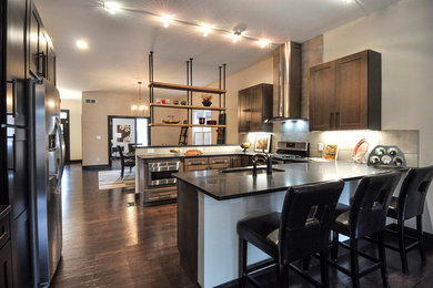 Large transitional u-shaped open concept kitchen photo in St Louis with an undermount sink, shaker cabinets, gray cabinets, granite countertops, gray backsplash, porcelain backsplash, stainless steel appliances and no island