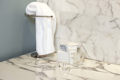 Inspiration for a transitional master white tile bathroom remodel in Chicago with dark wood cabinets, blue walls and marble countertops