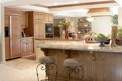 Eat-in kitchen - large traditional ceramic tile eat-in kitchen idea in Los Angeles with an undermount sink, raised-panel cabinets, light wood cabinets, granite countertops, black appliances and an island