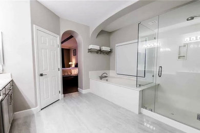 Bathroom - mid-sized traditional master cement tile floor and single-sink bathroom idea in Los Angeles with raised-panel cabinets, gray cabinets, a drop-in sink, a hinged shower door, white countertops and a built-in vanity
