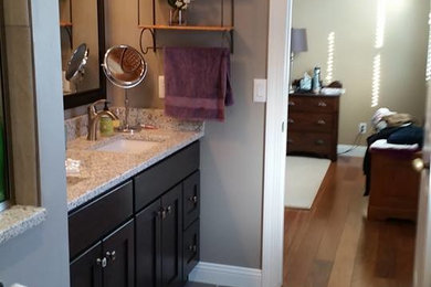 Bathroom - mid-sized traditional master porcelain tile and gray floor bathroom idea in Phoenix with shaker cabinets, dark wood cabinets, gray walls, an undermount sink and granite countertops