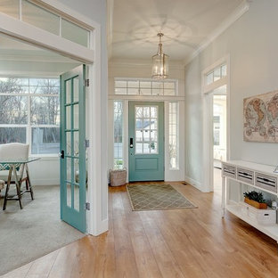 Immagine di un grande ingresso chic con pareti blu, parquet chiaro, una porta singola e una porta blu