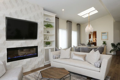 Transitional open concept vinyl floor and brown floor living room photo in San Diego with beige walls and a stone fireplace