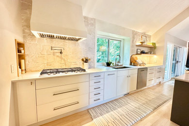 Large galley eat-in kitchen in Detroit with a single-bowl sink, shaker cabinets, white cabinets, quartzite benchtops, beige splashback, cement tile splashback, stainless steel appliances, light hardwood floors, with island, beige floor, white benchtop and exposed beam.