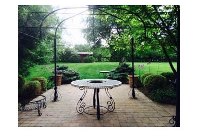 Patio - large contemporary backyard brick patio idea in Philadelphia