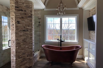 Large transitional master bathroom in Philadelphia with recessed-panel cabinets, dark wood cabinets, a claw-foot tub, a corner shower, a two-piece toilet, beige tile, stone tile, beige walls, medium hardwood floors, a drop-in sink, granite benchtops, brown floor, a hinged shower door and beige benchtops.