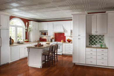 This is an example of a mid-sized traditional l-shaped kitchen in Dallas with a single-bowl sink, shaker cabinets, white cabinets, granite benchtops, red splashback, ceramic splashback, white appliances, dark hardwood floors, with island and brown floor.