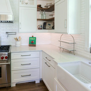 White Kitchen with Gray Quartz Countertops, Farmhouse Sink and Hardwood Floors