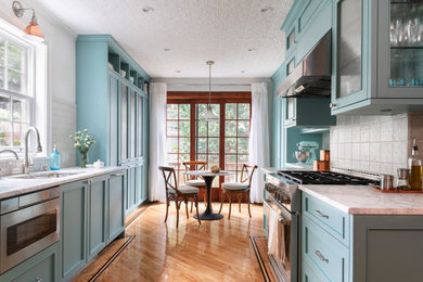 Kitchen - mid-sized transitional galley light wood floor and beige floor kitchen idea in New York with an undermount sink, shaker cabinets, blue cabinets, marble countertops, white backsplash and white countertops