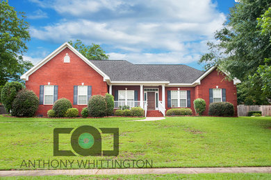 Inspiration for a timeless one-story brick exterior home remodel in Other