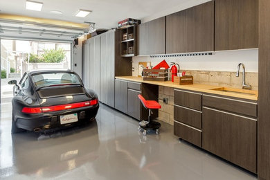 Example of a small minimalist attached one-car garage design in Los Angeles