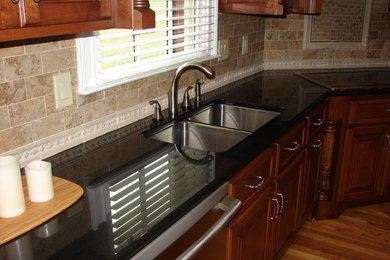 Example of a kitchen design with granite countertops