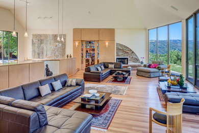 Inspiration for a huge contemporary open concept medium tone wood floor and beige floor living room remodel in San Francisco with white walls