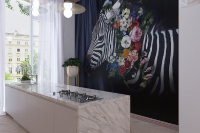Mid-sized trendy galley open concept kitchen photo in London with flat-panel cabinets, light wood cabinets, marble countertops, an island and multicolored countertops