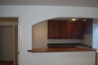 Mid-sized elegant underground carpeted basement photo in Denver with white walls