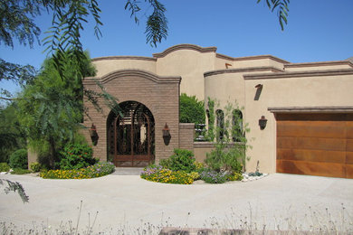 Large mediterranean beige one-story mixed siding exterior home idea in Phoenix