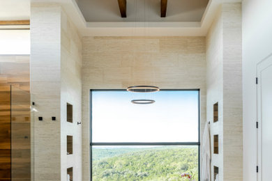 Inspiration for a contemporary travertine floor, double-sink and exposed beam drop-in bathtub remodel in Other with gray cabinets