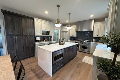 Enclosed kitchen - large contemporary u-shaped medium tone wood floor and brown floor enclosed kitchen idea in New York with a farmhouse sink, shaker cabinets, gray cabinets, quartz countertops, gray backsplash, porcelain backsplash, stainless steel appliances, an island and white countertops