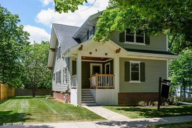 This is an example of a gey farmhouse house exterior in Chicago.