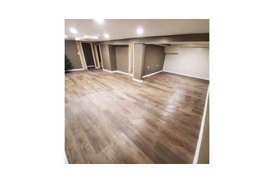Basement - traditional underground vinyl floor basement idea in Chicago with brown walls